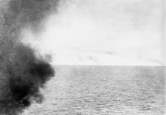 Photograph taken from the masthead of HMS Invincible by Paymaster Sub-Lieutenant Duckworth RN as the chase began in the Battle of the Falkland Islands on 8th December 1914. The smoke from the German ships can be seen on the horizon