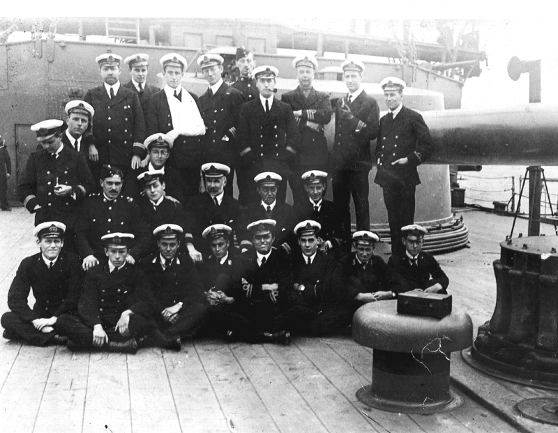 Photograph of some of the officers of HMS Good Hope taken in the Falkland Islands in October 1914. None of these officers survived the destruction of the Good Hope at the Battle of Coronel on 1st November 1914. The three Canadian midshipmen are third, fourth and seventh in the front row (Mid. A. W. Silver, RCN; Mid. M. Cann, RCN; Mid. W. A. Palmer, RCN).