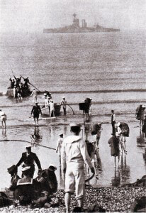 Royal Navy landing party at Mudros on the Greek island of Lemnos with a battleship in the background