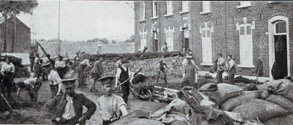 Soldiers of 1st Northumberland Fusiliers preparing street barricades in the Mons area before the fighting started on 23rd August 1914